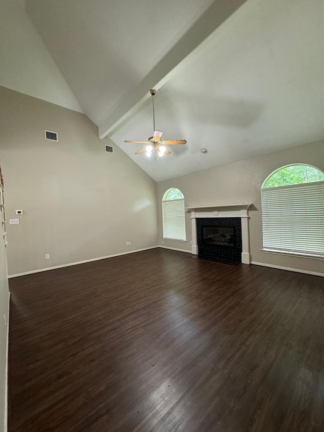 2232 Stableridge Dr, Conroe, TX 77384 - unfurnished living room featuring a ceiling fan, dark wood-style flooring, beamed ceiling, a glass covered fireplace, and baseboards