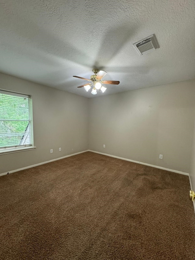 2232 Stableridge Dr, Conroe, TX 77384 - empty room with a ceiling fan, carpet, baseboards, and a textured ceiling