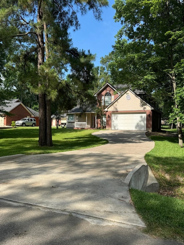 2232 Stableridge Dr, Conroe, TX 77384 - view of front of property featuring a garage, a front yard, and concrete driveway