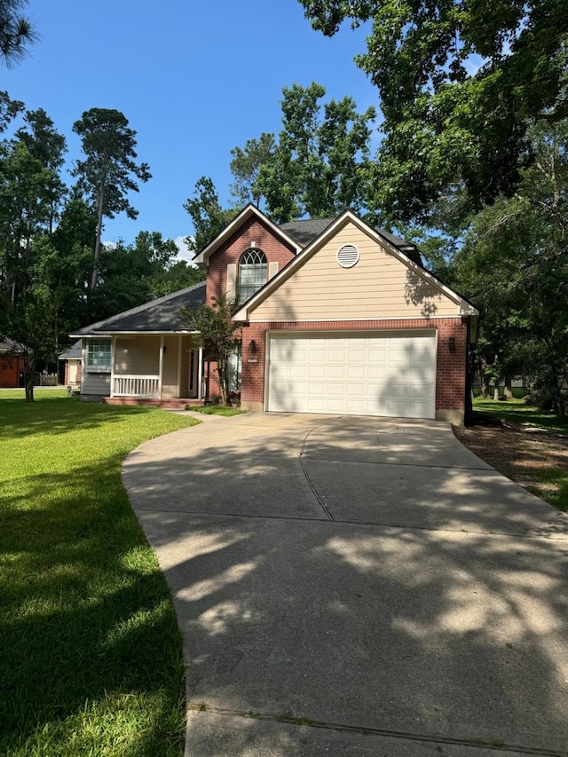 2232 Stableridge Dr, Conroe, TX 77384 - view of front facade with a front lawn, concrete driveway, an attached garage, and brick siding