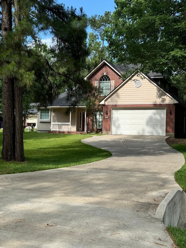 2232 Stableridge Dr, Conroe, TX 77384 - view of front facade featuring driveway, a garage, a front lawn, and brick siding