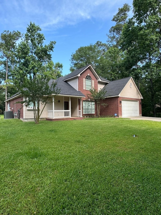 2232 Stableridge Dr, Conroe, TX 77384 - view of front of home with an attached garage, a porch, a front lawn, and concrete driveway