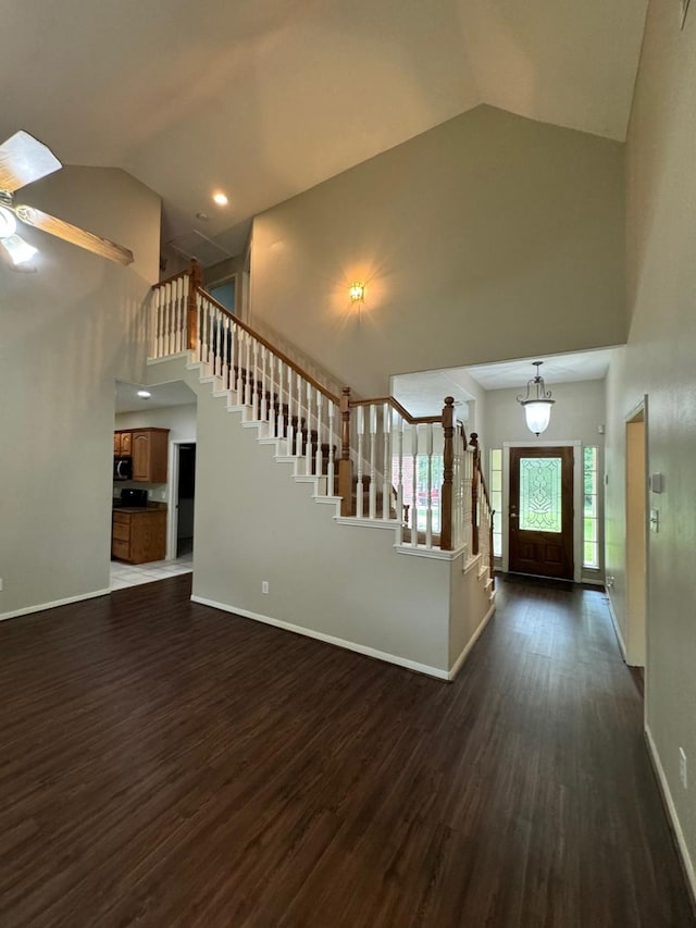 2232 Stableridge Dr, Conroe, TX 77384 - foyer with high vaulted ceiling, stairway, dark wood-style floors, baseboards, and a ceiling fan