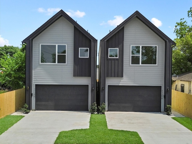 7729 Ave J Unit A, Houston, TX 77012 - contemporary home with an attached garage, driveway, and board and batten siding