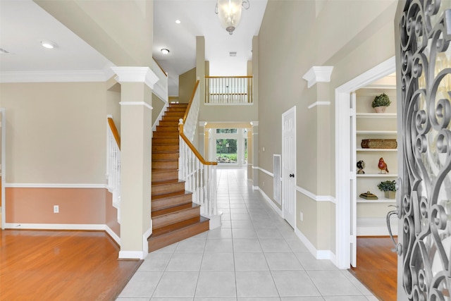 14806 Cantwell Bnd, Cypress, TX 77429 - foyer entrance featuring stairs, light tile patterned flooring, ornamental molding, and a high ceiling