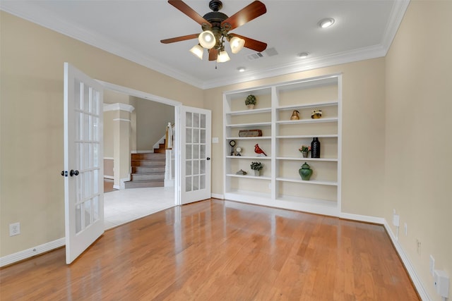 14806 Cantwell Bnd, Cypress, TX 77429 - spare room featuring french doors, wood finished floors, crown molding, ceiling fan, and stairs