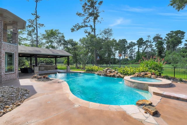 14806 Cantwell Bnd, Cypress, TX 77429 - view of swimming pool with a patio area, a pool with connected hot tub, an outdoor kitchen, and a gazebo