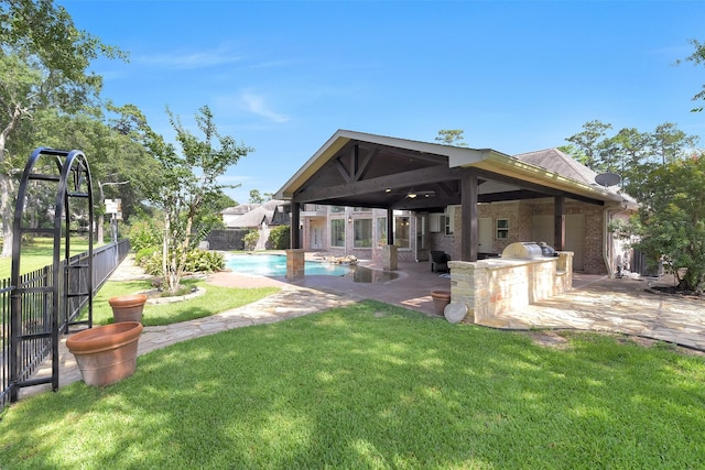 14806 Cantwell Bnd, Cypress, TX 77429 - back of house featuring an outdoor kitchen, a fenced backyard, and a patio