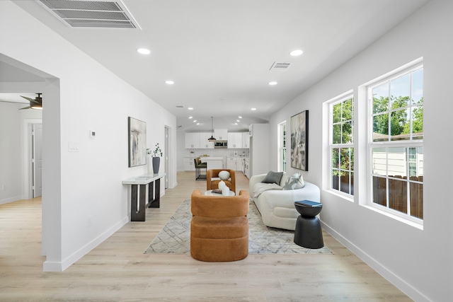 1310 E 34th St, Houston, TX 77022 - living area with light wood-style flooring, baseboards, recessed lighting, and a ceiling fan