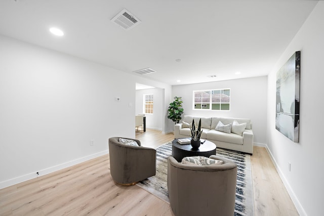 1310 E 34th St, Houston, TX 77022 - living area with light wood-style flooring, baseboards, and recessed lighting