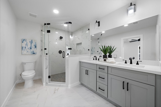 1310 E 34th St, Houston, TX 77022 - full bathroom featuring double vanity, toilet, a marble finish shower, baseboards, and marble finish floors