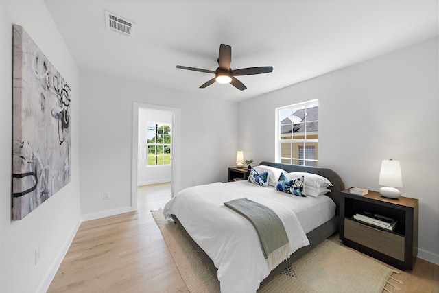1310 E 34th St, Houston, TX 77022 - bedroom featuring baseboards, light wood-style floors, and a ceiling fan