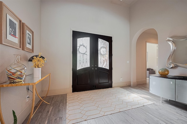 13707 Rivendell Crest Ln, Cypress, TX 77429 - entryway with light wood finished floors, arched walkways, and french doors