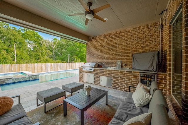 13707 Rivendell Crest Ln, Cypress, TX 77429 - fenced backyard featuring an outdoor kitchen, a ceiling fan, outdoor lounge area, a patio area, and a pool with connected hot tub