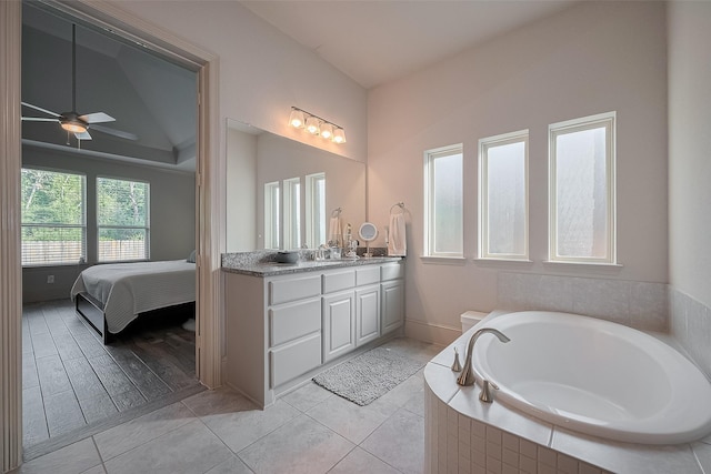 13707 Rivendell Crest Ln, Cypress, TX 77429 - ensuite bathroom featuring vanity, a garden tub, ceiling fan, and tile patterned floors