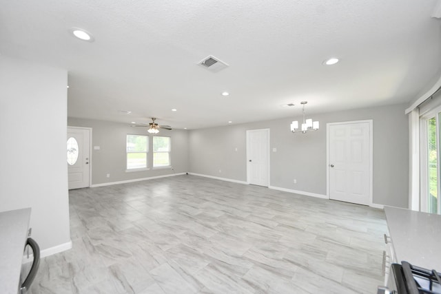 5911 Southurst St, Houston, TX 77033 - unfurnished living room with a chandelier, plenty of natural light, ceiling fan, recessed lighting, and baseboards
