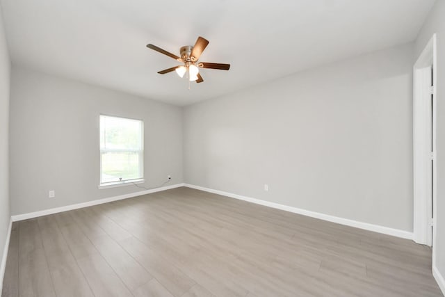 5911 Southurst St, Houston, TX 77033 - empty room featuring a ceiling fan, baseboards, and light wood-style flooring
