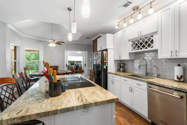 1523 Lofty Maple Trl, Kingwood, TX 77345 - kitchen featuring black appliances, a sink, ornamental molding, backsplash, and light stone counters
