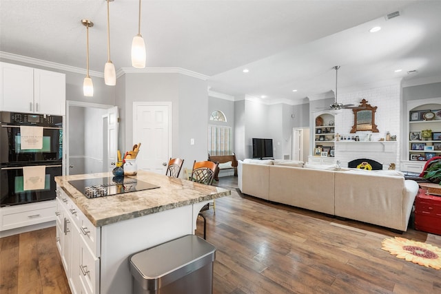 1523 Lofty Maple Trl, Kingwood, TX 77345 - kitchen featuring black appliances, ornamental molding, ceiling fan, a kitchen island, and white cabinetry