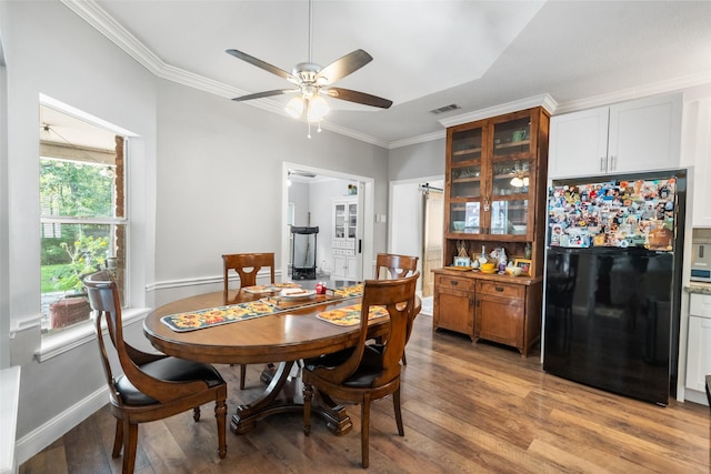 1523 Lofty Maple Trl, Kingwood, TX 77345 - dining space with a ceiling fan, crown molding, light wood-style floors, and baseboards