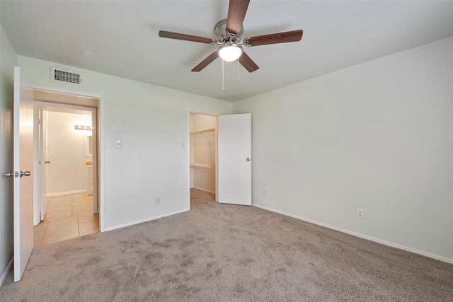 12500 Sandpiper Dr Unit 5, Houston, TX 77035 - unfurnished bedroom featuring carpet floors, a spacious closet, baseboards, and a ceiling fan