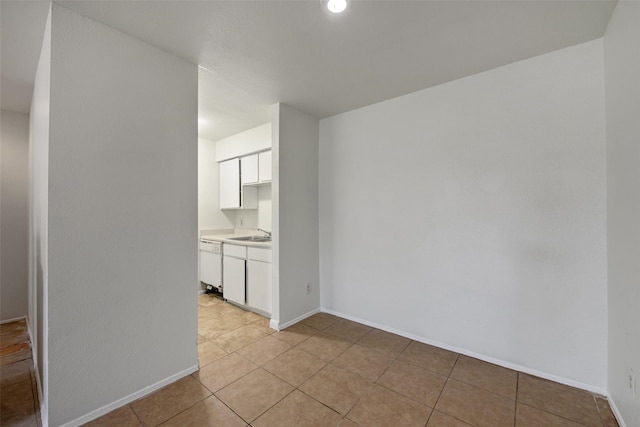 12500 Sandpiper Dr Unit 5, Houston, TX 77035 - spare room featuring light tile patterned flooring, baseboards, and a sink