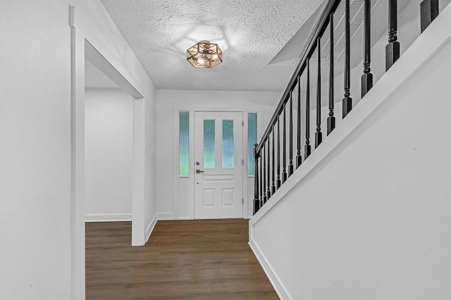 16218 Coral Bay St, Crosby, TX 77532 - foyer entrance with wood finished floors, baseboards, and a textured ceiling