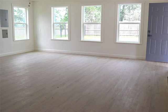 16218 Coral Bay St, Crosby, TX 77532 - empty room featuring electric panel, light wood-type flooring, and baseboards