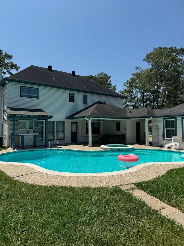 16218 Coral Bay St, Crosby, TX 77532 - swimming pool featuring an in-ground hot tub, a patio area, and a lawn