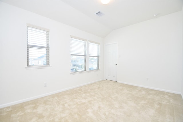 14623 Monterey Cypress Dr, Houston, TX 77068 - spare room with light carpet, vaulted ceiling, and baseboards