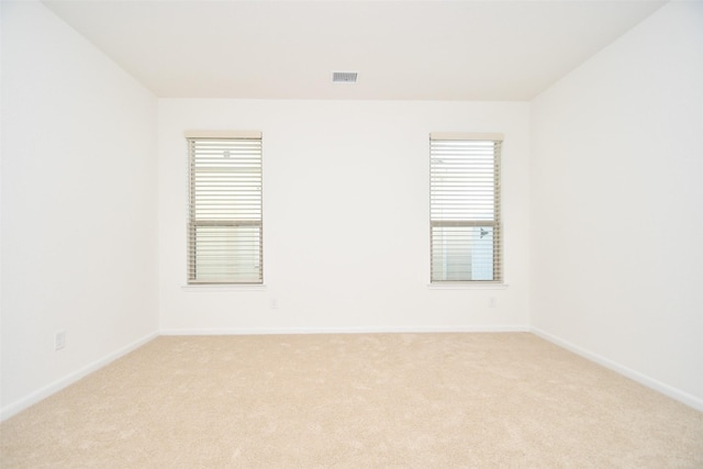 14623 Monterey Cypress Dr, Houston, TX 77068 - empty room featuring light carpet, baseboards, and healthy amount of natural light
