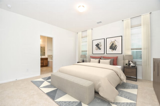 14623 Monterey Cypress Dr, Houston, TX 77068 - bedroom featuring light carpet, ensuite bathroom, and baseboards