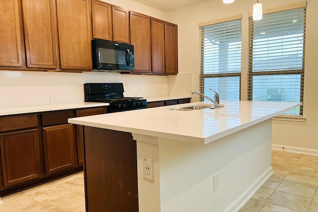 14623 Monterey Cypress Dr, Houston, TX 77068 - kitchen featuring black appliances, light countertops, decorative light fixtures, a kitchen island with sink, and light tile patterned flooring