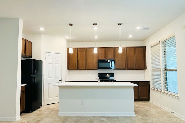 14623 Monterey Cypress Dr, Houston, TX 77068 - kitchen featuring black appliances, light countertops, pendant lighting, an island with sink, and baseboards