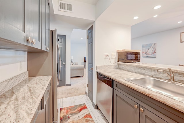 5863 Inwood Dr Unit 5, Houston, TX 77057 - kitchen featuring dishwasher, a sink, black microwave, recessed lighting, and light stone countertops