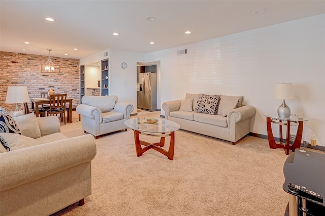 5863 Inwood Dr Unit 5, Houston, TX 77057 - living room featuring brick wall, light colored carpet, and recessed lighting
