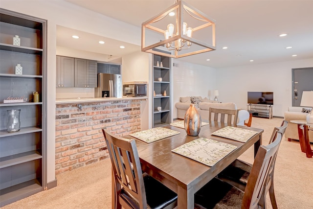 5863 Inwood Dr Unit 5, Houston, TX 77057 - dining area featuring light carpet, recessed lighting, and a chandelier
