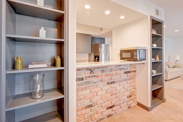 5863 Inwood Dr Unit 5, Houston, TX 77057 - bar featuring black microwave, stainless steel refrigerator with ice dispenser, carpet floors, and recessed lighting
