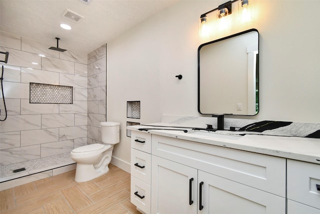1003 Crescent Blvd, Cleveland, TX 77327 - bathroom featuring vanity, toilet, a tile shower, and baseboards