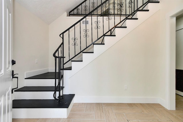 1003 Crescent Blvd, Cleveland, TX 77327 - staircase with baseboards and a textured ceiling