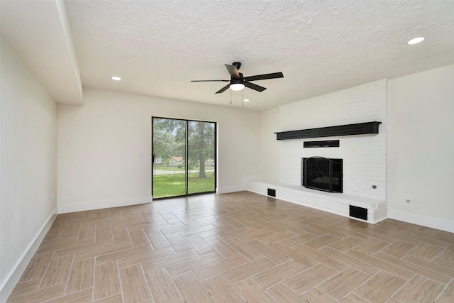 1003 Crescent Blvd, Cleveland, TX 77327 - unfurnished living room featuring baseboards, a ceiling fan, a fireplace, a textured ceiling, and recessed lighting