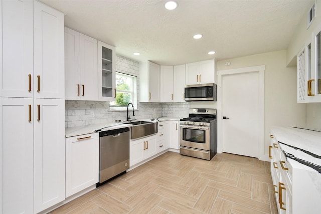 1003 Crescent Blvd, Cleveland, TX 77327 - kitchen featuring appliances with stainless steel finishes, a sink, recessed lighting, white cabinets, and decorative backsplash
