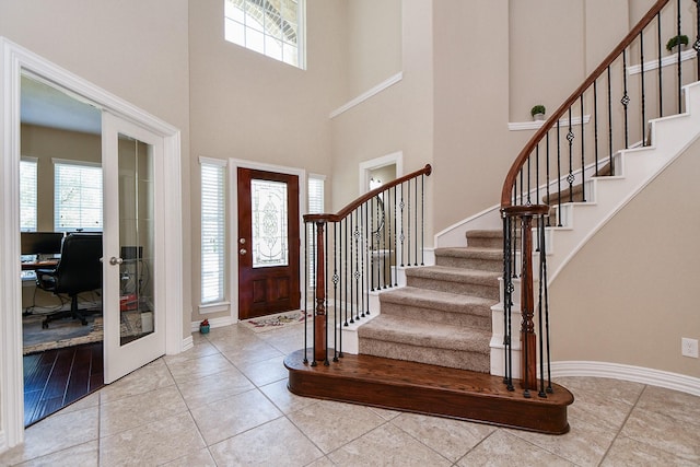 26706 Grey Swan Dr, Katy, TX 77494 - foyer featuring plenty of natural light, a high ceiling, stairway, and baseboards