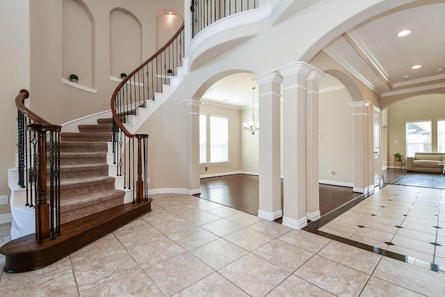26706 Grey Swan Dr, Katy, TX 77494 - tiled entryway with healthy amount of natural light, arched walkways, ornate columns, crown molding, and a high ceiling