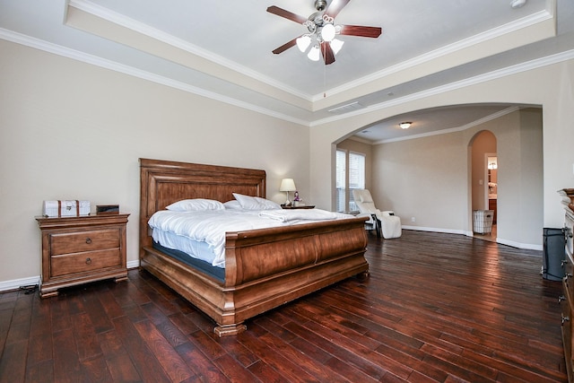 26706 Grey Swan Dr, Katy, TX 77494 - bedroom with a raised ceiling, arched walkways, hardwood / wood-style floors, and baseboards