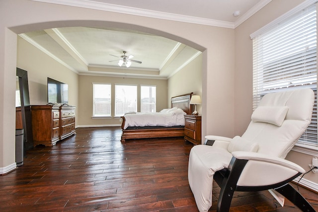 26706 Grey Swan Dr, Katy, TX 77494 - bedroom featuring arched walkways, dark wood-style floors, crown molding, a raised ceiling, and baseboards