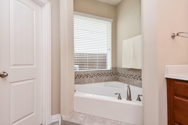 26706 Grey Swan Dr, Katy, TX 77494 - bathroom with healthy amount of natural light, a bath, vanity, and tile patterned floors
