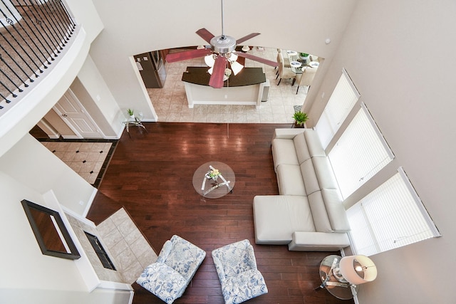 26706 Grey Swan Dr, Katy, TX 77494 - unfurnished living room featuring a high ceiling, ceiling fan, tile patterned flooring, and baseboards