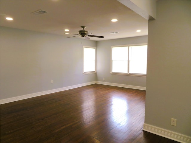 1103 Jocelyn St, Houston, TX 77023 - empty room with a ceiling fan, dark wood-style floors, recessed lighting, and baseboards
