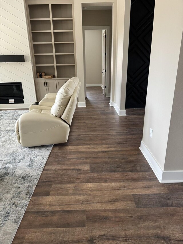 262 Rd 660, Dayton, TX 77535 - living room featuring baseboards, dark wood finished floors, a fireplace, and built in shelves